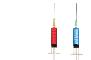 Two full syringes of different drugs