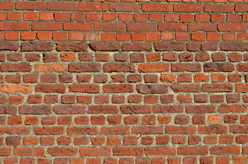 Brick wall with old bricks on top of young ones, house in Flanders