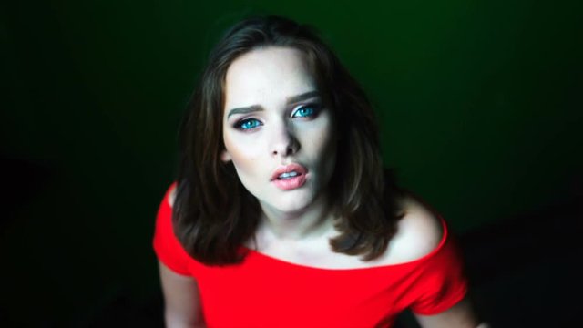beauty woman with mesmerising eyes and red dress 