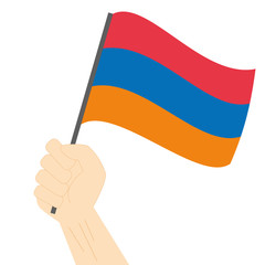 Hand holding and raising the national flag of Armenia