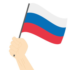 Hand holding and raising the national flag of Russia
