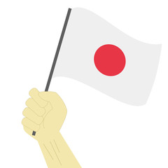 Hand holding and raising the national flag of Japan