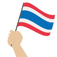 Hand holding and raising the national flag of Thailand