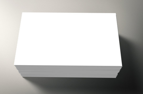 stack of white blank name card on grey background