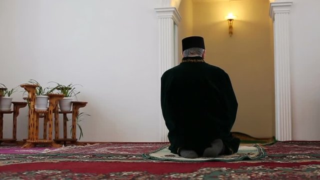 An old mullah reading the Koran in mosque. Slow motion