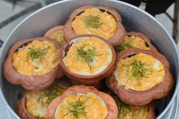 steamed fish with curry paste in clay pot in steaming pot