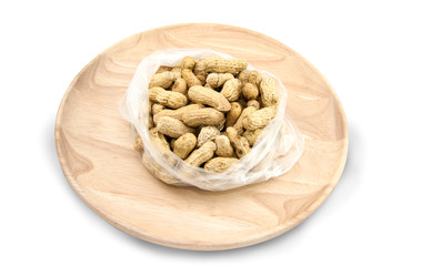Wooden dish of nuts on white wooden background