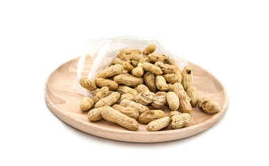 Wooden dish of nuts on white wooden background