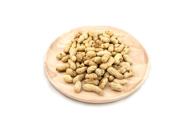 Wooden dish of nuts on white wooden background