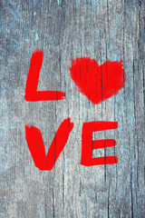 Word "Love" painted on old wooden wall background