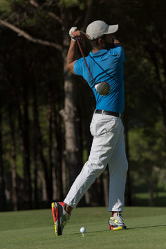 golf player hitting shot