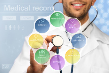 Doctor with stethoscope and medicine icons on virtual screen. Medical concept