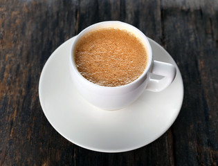 Cup of hot coffee on rustic wooden background