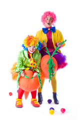 two funny colorful clown fooling around on a white background