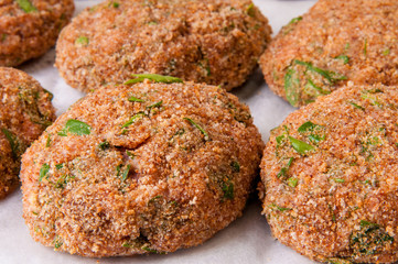 Uncooked cutlets with fresh herbs