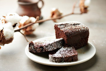 Tasty chocolate cake and cotton flowers