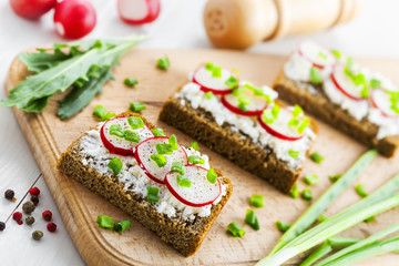 Ray bread with soft cream cheese and radish. Delicious vegetarian food.