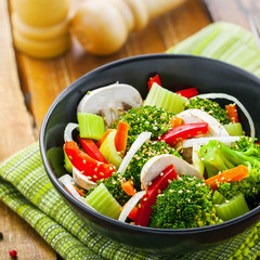 Healthy food made of broccoli, onion, mushroom, carrot and pepper. Vegetarian salad.