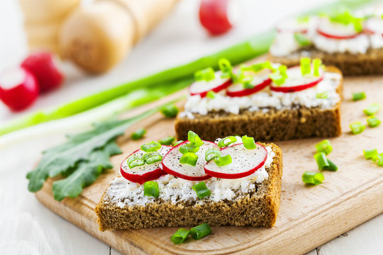 Delicious sandwiches with soft cream cheese and radish.  Vegetarian food.