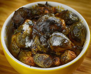 Roasted Brussells sprouts in yellow ceramic dish