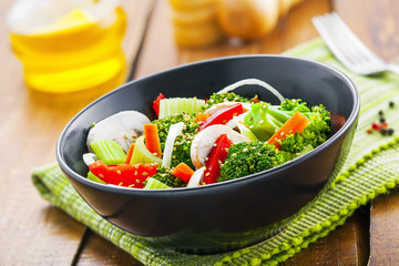 Healthy vegetable salad made of steamed broccoli, onion, mushroom, carrot and pepper. Vegetarian food.
