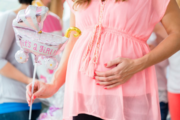 Pregnant girl celebrating baby shower party with friends