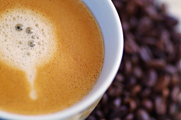 Coffee. Cup of coffee. Hot coffee. Cup of coffee and coffee beans. Coffee with foam.