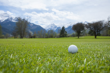 detail of golf ball on grass
