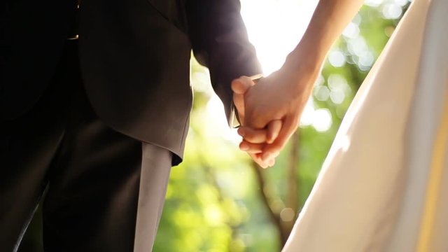 Marry Me Today And Everyday. Newlywed Couple Holding Hands, Shot In Slow Motion