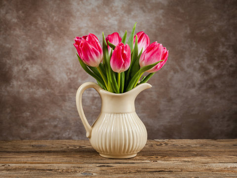 Beautiful tulips bouquet on wooden table. Spring flowers.