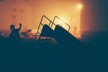 Several zombie on the street at night.