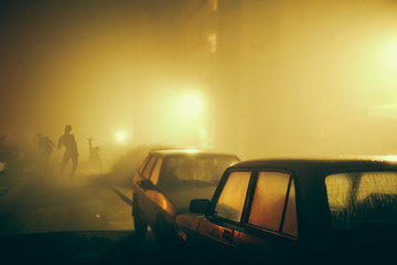 Several zombie on the street at night.