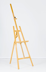 Wooden easel in white room