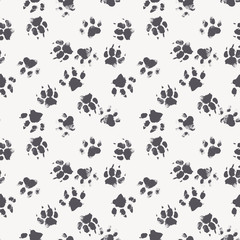 Vector seamless pattern with paw footprints of a dog © lumitar