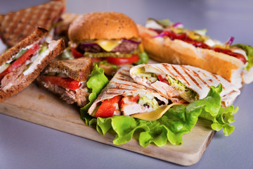 Fast food plate with burger hot dog sandwiches and chicken wrap