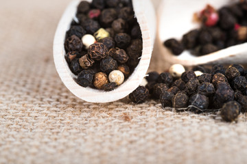 Wooden scoop with dried pepper berries