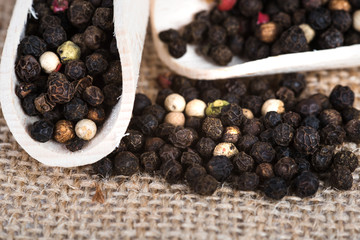 Wooden scoop with dried pepper berries