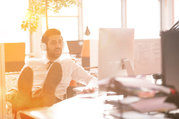 relaxed young businessman first at workplace at early morning