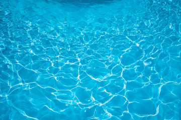 Fototapeta na wymiar Ripple water surface and sun reflection in swimming pool