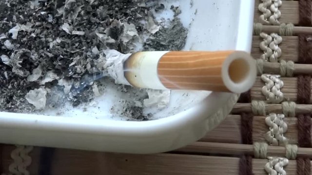 Top view of smoking filter cigarette in ashtray 