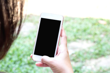 Closeup hand using smart  phone outdoor, clipping path inside