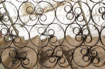 Fototapeta na wymiar Closeup Details of a Black Wrought Iron Fence