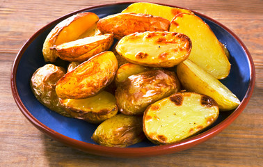 Fried potato on a wooden table
