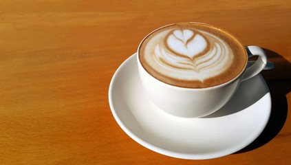 Cup of coffee with painted heart on foam