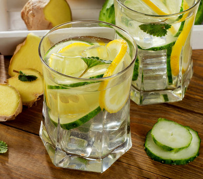 Fresh water with lemon, mint  and cucumber  on a wooden backgrou