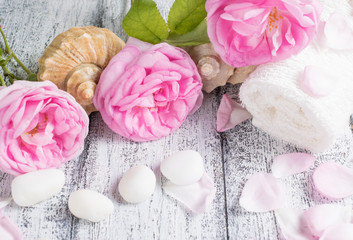 Spa salon with towel, sea pebbles and roses
