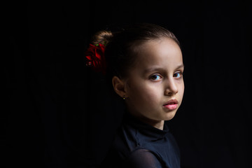 portrait of young girl at black background