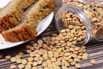 Lentil spilling out of glass jar and homemade pie