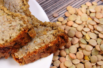 Heap of lentil and homemade pie on wooden background