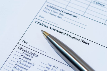 Medical record form with pen